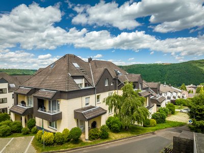 Apartment with View Row houses in a green landscape under blue sky with clouds