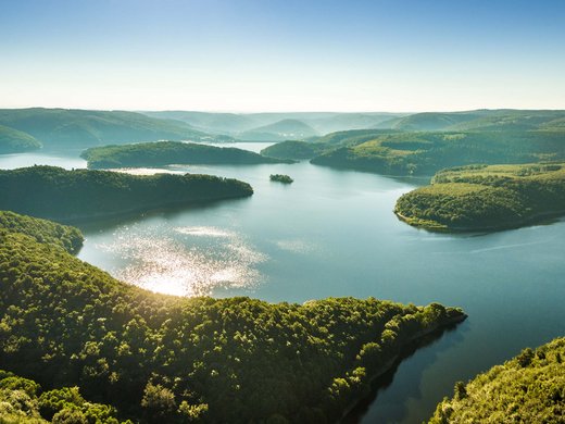 A holiday apartment in Schleiden-Gemünd at the national park Aerial view of a large reservoir surrounded by forest with sparkling water