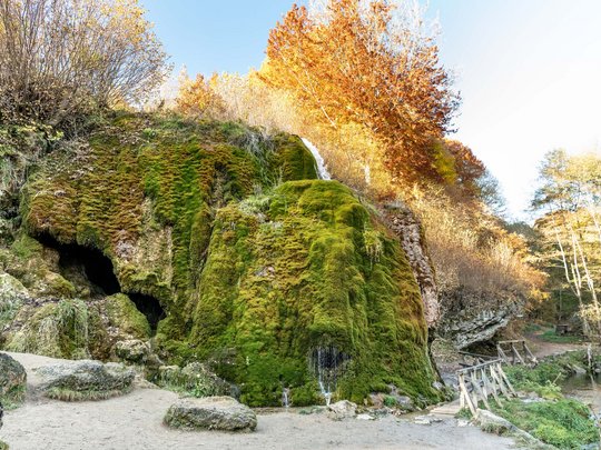 Holiday apartments in Gemünd with special flair Moss-covered rock with small waterfall and autumn trees